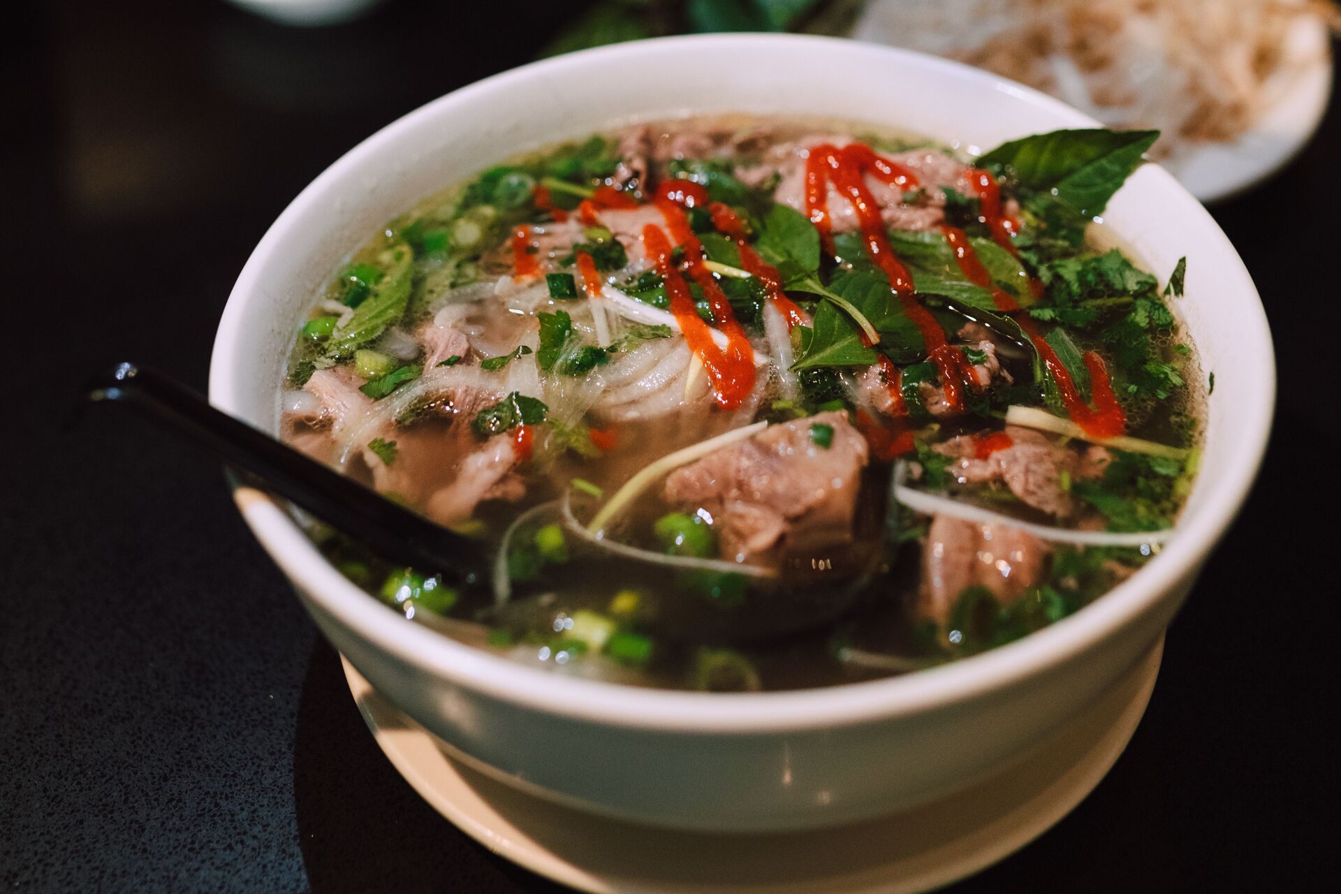 delicious-bowl-of-traditional-vietnamese-pho-garnished-with-fresh-herbs-and-spicy-sauce-6qdFkU9ugc9DEOp0ClsDVA