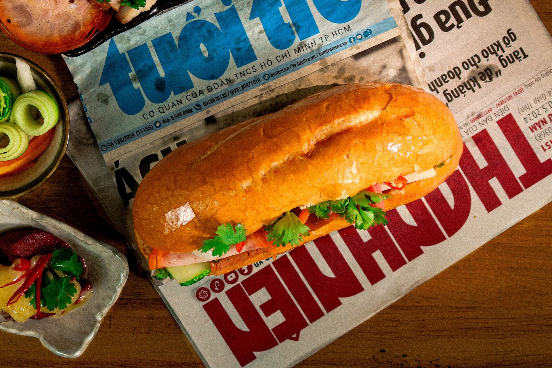 traditional-vietnamese-banh-mi-sandwich-placed-on-local-newspaper-surrounded-by-fresh-ingredients-offering-a-cultural-and-gastronomic-glimpse-of-viet-nam-SQtSIlJPYSdnQAgPmMldqQ